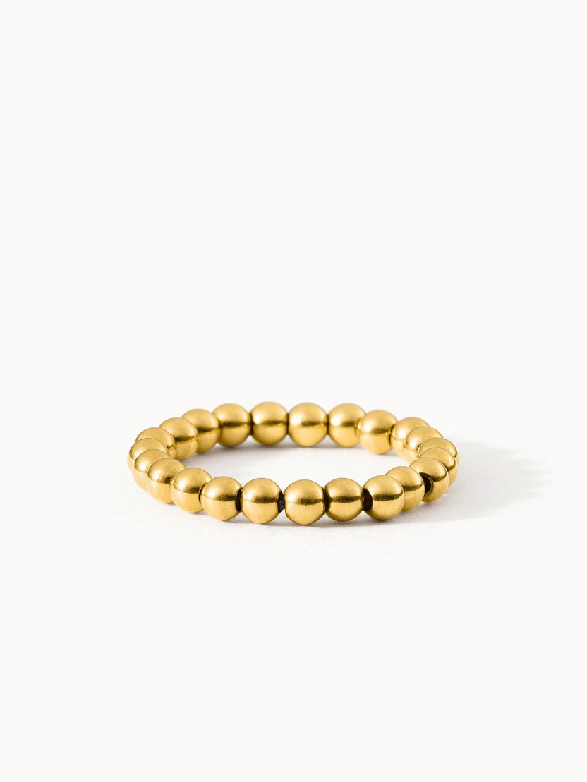 Goldenes, allergenfreundliches Ringarmband von PURELEI mit glänzenden Kugeln.
