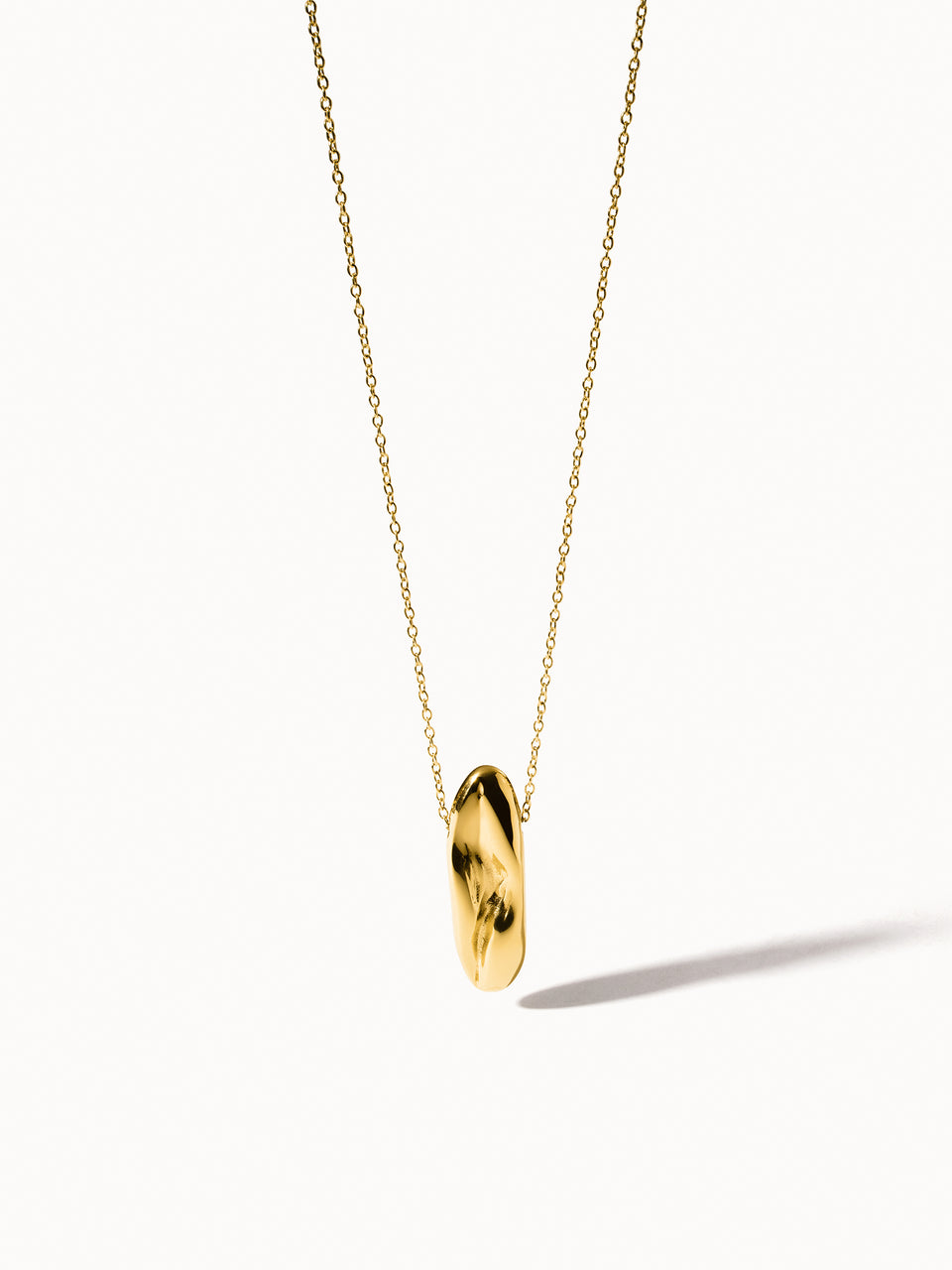 Goldene PURELEI Kette mit geschwungenem Anhänger, elegant und modern.
