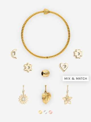 Goldenes Armband mit verschiedenen Charms von PURELEI, elegant und verspielt.