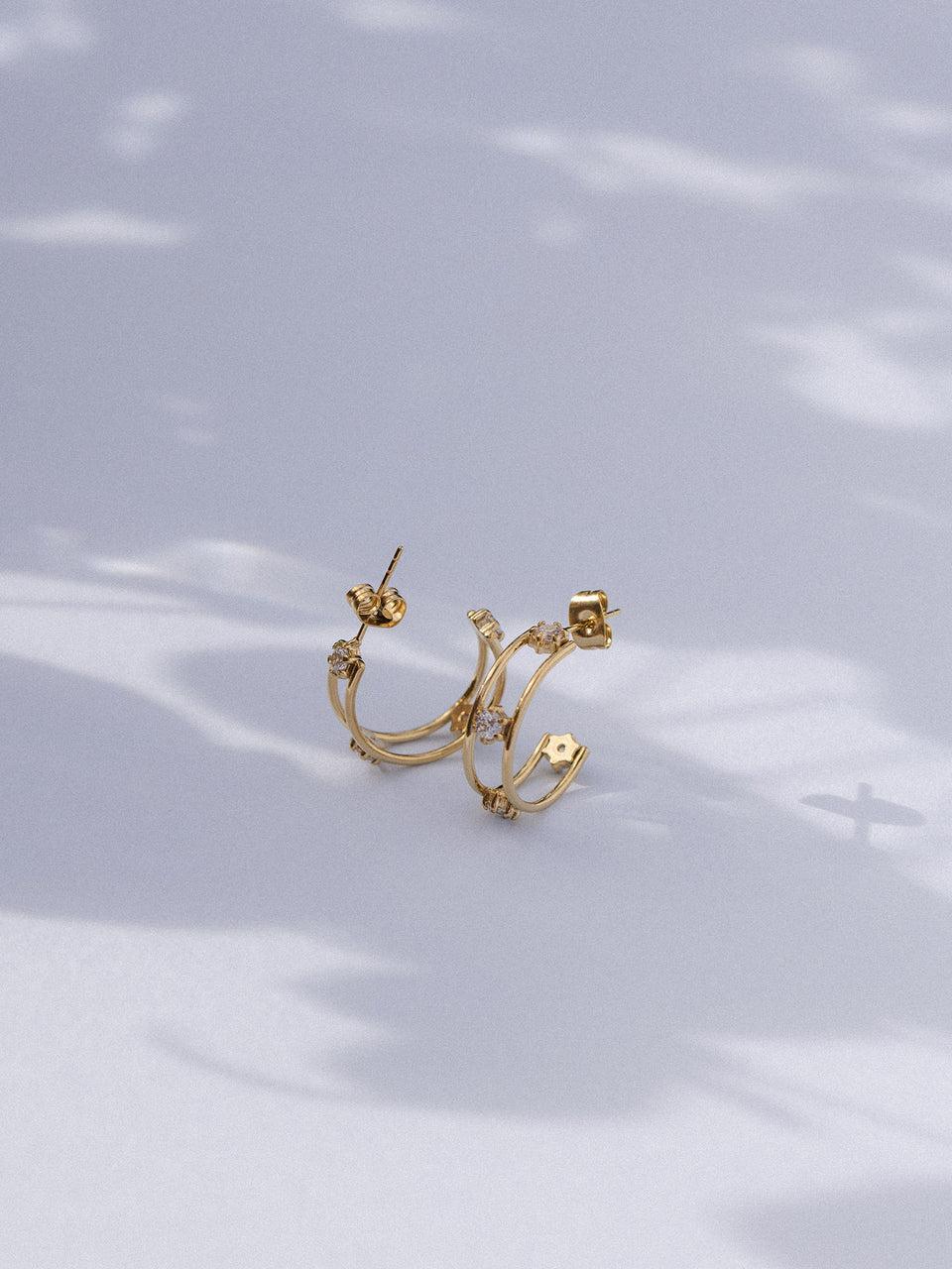 Silberne Creolen von PURELEI auf sanftem Hintergrund, elegant und modern.