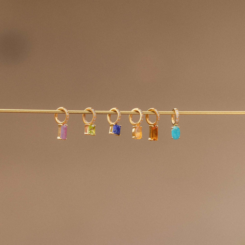 Goldene Anhänger mit bunten Steinen auf feinem Draht, PURELEI inspiriert.